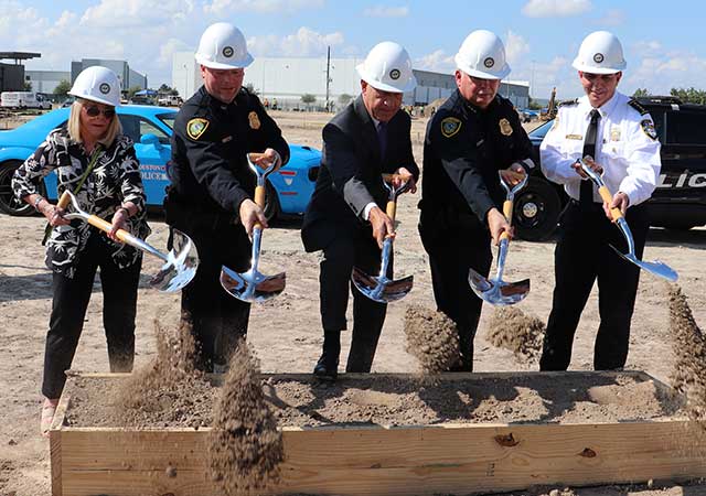 HPD North Belt Station 7 City and police officials wearing hard hats toss dirt with ceremonial shovels during the groundbreaking for the new Houston Police Department North Belt Station.