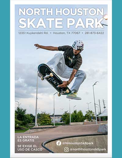 A man jumping in the air with a skateboard at North Houston Skate Park