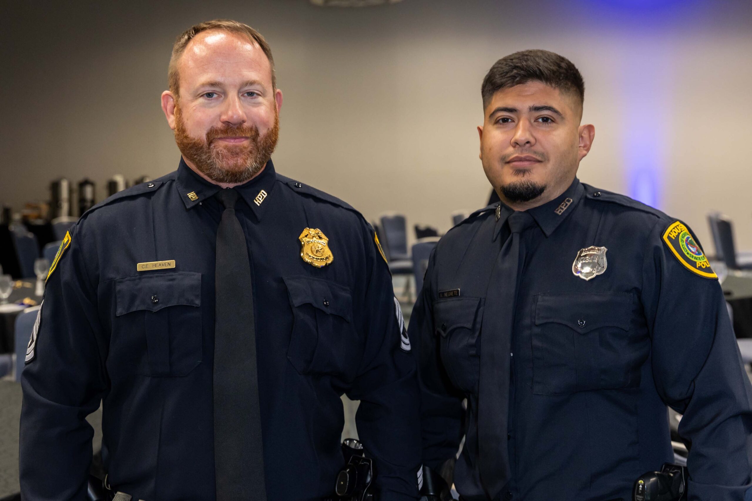 Two HPD officers in dress uniforms smile for a photo at the luncheon.