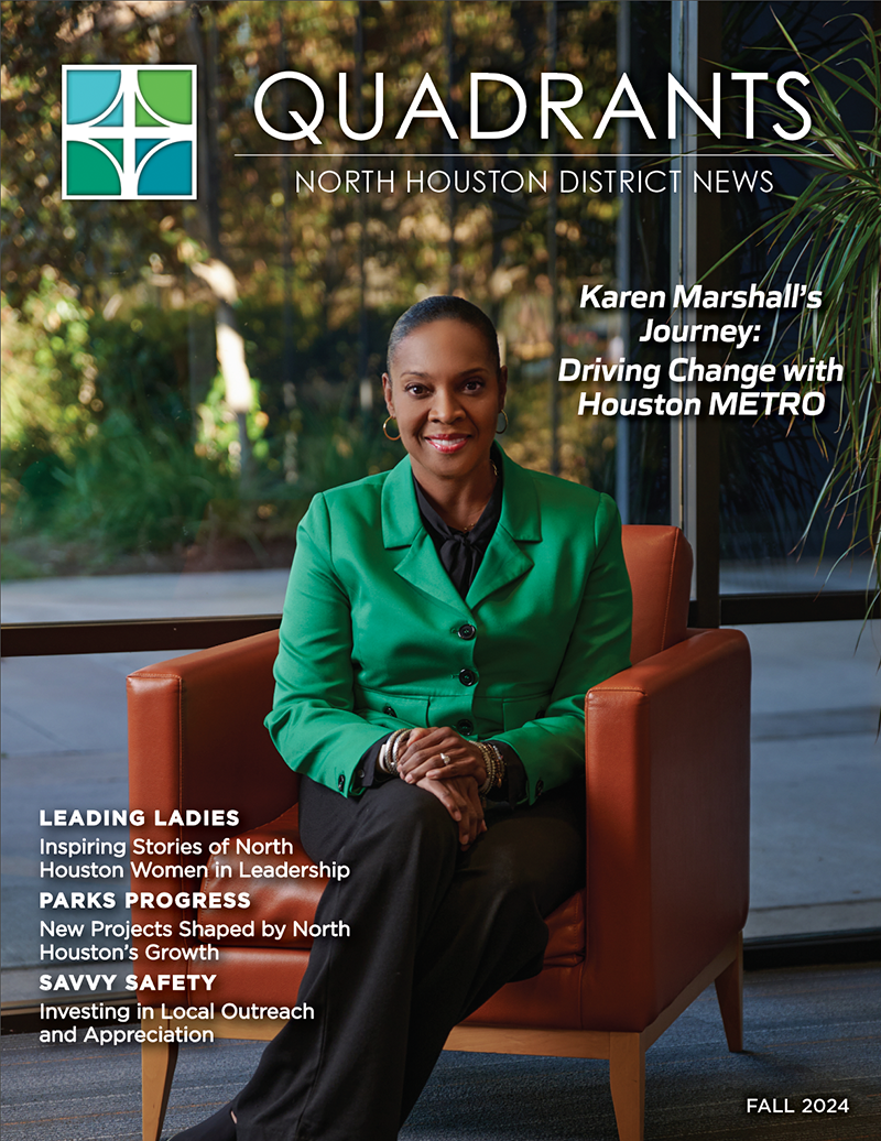 The image is the cover of Quadrants: North Houston District News for Fall 2024. It features Karen Marshall seated in an orange chair, wearing a green blazer and smiling confidently. The background includes large windows and greenery. The title reads, "Karen Marshall's Journey: Driving Change with Houston METRO." Highlights include "Leading Ladies," "Parks Progress," and "Savvy Safety," showcasing stories about leadership, community growth, and outreach. The North Houston District logo is in the upper-left corner.